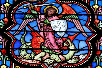 Bayeux cathedral. Stained glass. Saint  Michael slaying the dragon, symbolizing the victory of good over evil.  Bayeux.  France.