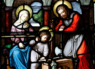 Fototapeta premium Church of the Cordeliers. Stained glass. Holy Family. Joseph the carpenter. Lons le Saunier. France.