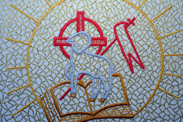Catholic mass. Liturgical embroidery featuring the Lamb of God (Agnus Dei) standing on the Gospels,  La Roche sur Foron.  France.