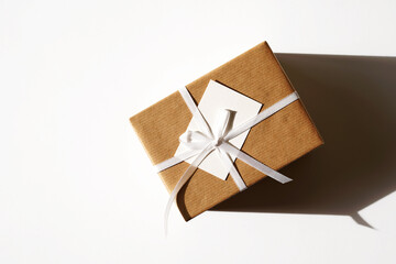 Birthday Present. Holidays Gift in Kraft Paper Tied with White Ribbon Bow. Christmas, New Year. Valentine's Day.                            