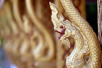 Fototapeta premium Wat Phramahathat Rajbovoravihane buddhist temple. Traditional buddhist golden dragon sculptures. Luang Prabang. Laos.