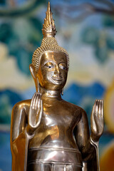 Wat Visounnarath buddhist temple. Wooden Buddha ( calling for the rain position ).  17 th - 18 th century. Wood, lacquer, gold leaf.  Luang Prabang. Laos. © Godong Photo
