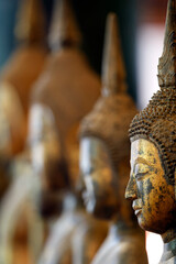 Fototapeta premium Wat Visounnarath buddhist temple. Wooden Buddha ( calling for the rain position ). 17 th - 18 th century. Wood, lacquer, gold leaf. Luang Prabang. Laos.