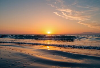 Fototapeta premium Sunset over ocean waves with glowing horizon and soft clouds