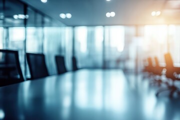 Fototapeta premium A blurred view of a modern conference room with a long table and chairs, illuminated by soft lighting, creating a professional atmosphere.