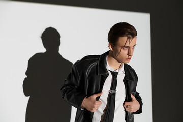 Stylish young man expressing modern youth culture with confidence in an artistic setting