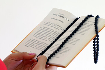 Buddhist liturgical book. Woman reading The teachings of the Buddha. The way of purification. ...