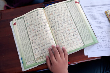 Fototapeta premium Quran in Arabic and its translation into English. Ho Chi Minh city. Vietnam.