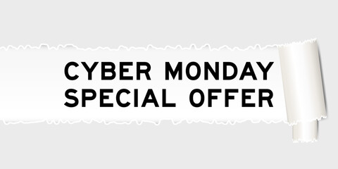 Ripped gray paper background that have word cyber monday special offer under torn part