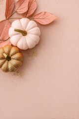 Soft blush pumpkins and golden leaves on pastel beige background, minimalist autumn flat lay with delicate glitter accents and copy space for Thanksgiving or seasonal banner design