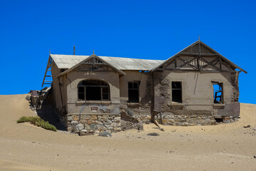 Kolmanskop, a ghost town in Namibia. Dilapidated and long-abandoned houses.
Today, the sands of the...
