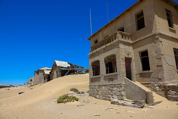 Kolmanskop, a ghost town in Namibia. Dilapidated and long-abandoned houses.
Today, the sands of the...