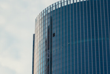 Fototapeta premium mirrored windows of the facade of an office building