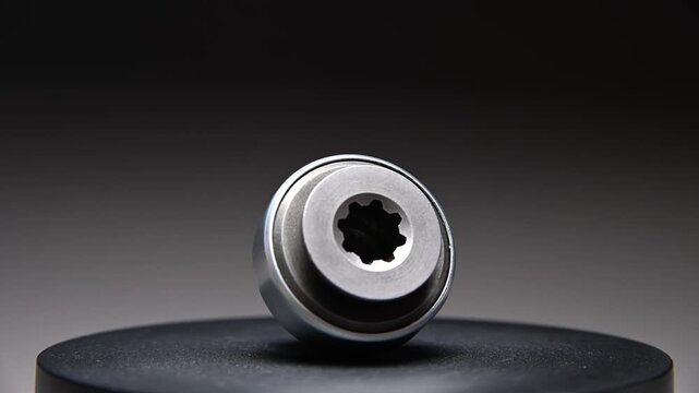 New parts are rotating. A Bendix starter gear drive for starting the engine on a gray gradient background. A classic gear drive transmits torque.