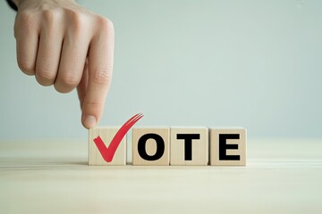Hand places red checkmark on wooden block spelling vote demonstrating election or voting participation