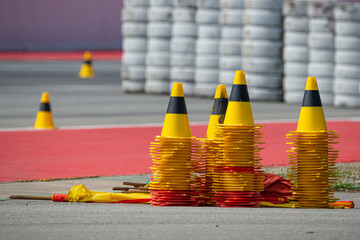 Stacked yellow and black guiding cones ready for a race or training course