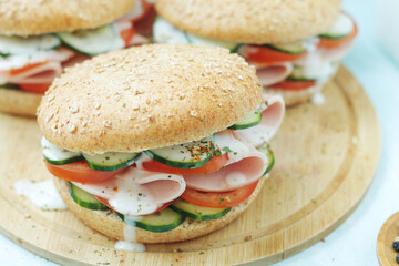 Bun sandwiches with salami and vegetables