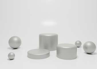 Trio of gray and white round podiums with metallic spheres on clean surface