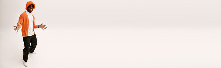 Handsome young man showcasing stylish fashion and confident expression in minimalist setting