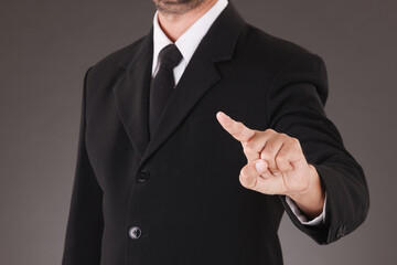 Asian Man standing and shows outstretched hand with Pointing Finger. COPY SPACE. No Face.