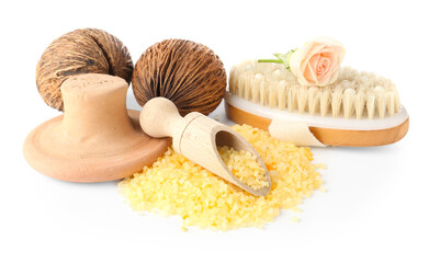Yellow sea salt, brush, clay massage tool, rose flower and scoop isolated on white