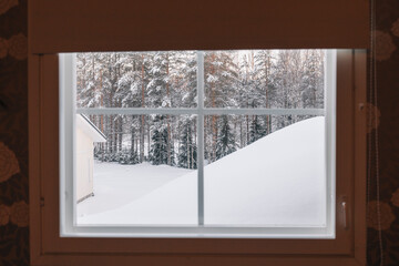 Snowy landscape viewed from window during winter