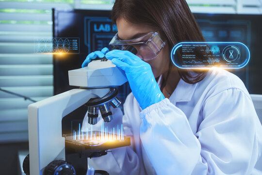 Asian female scientist in blue gloves and safety goggles uses a microscope to examine a sample, with holographic overlays displaying DNA and waveform data in a high-tech research lab. - Powered by Adobe
