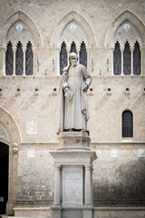 Obraz premium Statue of Sallustio Bandini at Piazza Salimbeni - the Main Office of Monte dei Paschi Bank in Siena, Italy