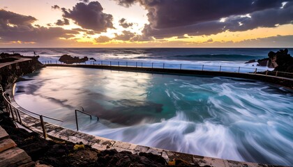 Dramatic sunset over a natural pool