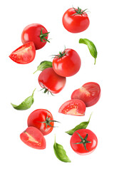 Fresh tomatoes and basil leaves flying on white background