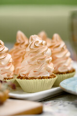 Close-up of delicate pink Swiss meringue tartlets with caramelized tops.