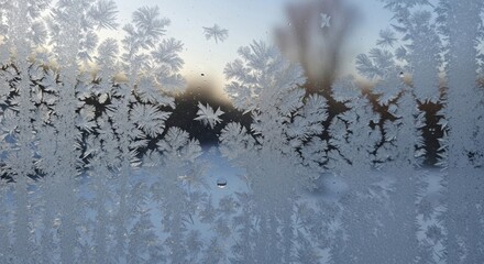 Ice crystals forming on a glass window in winter