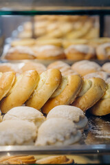 Close-up of fresh baked goods with cottage cheese filling on a bakery counter.