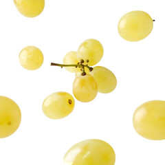 Isolated golden grapes, some halved, on black. Small bunch clustered around the stem