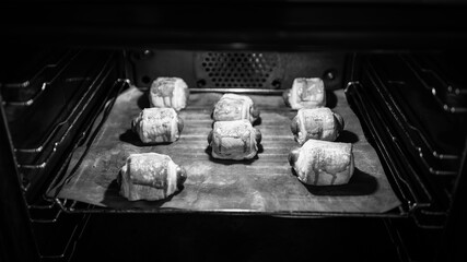 baked in the oven - black and white photo o vienna sausage in puff pastry