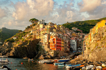 Riomaggiore is a village and comune in the province of La Spezia, Liguria, Cinque Terre, Italy. Golden hour in Riamaggiore, Italy. Riomaggiore is the most southern village of Cinque Terre