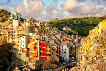 Riomaggiore is a village and comune in the province of La Spezia, Liguria, Cinque Terre, Italy. Golden hour in Riamaggiore, Italy. Riomaggiore is the most southern village of Cinque Terre