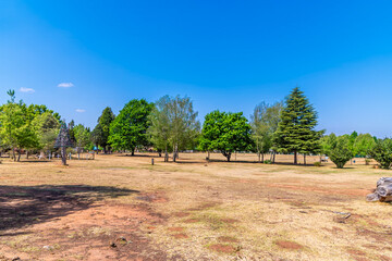 A view across the dry grass park in the centre of Dullstroom, South Africa in Springtime