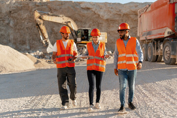 Group of professional multinational engineers discussing project plans at mining site