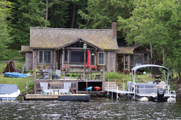 A cozy lakefront house with a dock and watercraft
