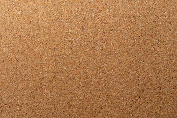 A natural, light brown corkboard or cork material. This textured background is ideal for presentations, concepts, bulletin boards, and environmentally friendly themes.