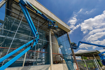 Male industry working at high in a boom lift inspection tank