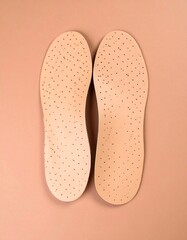 Two beige insoles, top-down view