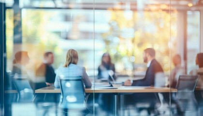 A group of businesspeople are seated around a table in a brightly lit conference room, viewed through a transparent glass partition.