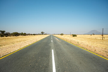 A road winding through the savanna north of Windhoek, Namibia