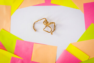 Soft pastel paper chat bubble with tangled burlap ropes in the center, illustrating messy communication, misinformation, and complexity in social media.