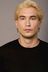 Young man embodying modern youth culture with style and confidence in a studio setting