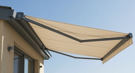 Retractable awning extended on building exterior under clear sky  