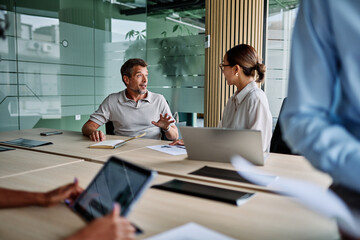 Fototapeta premium Portrait of young businesswoman and mid aged businessman having a meeting or presentation and seminar in the office