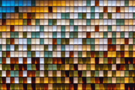 Colorful transparent glass bricks forming a decorative wall